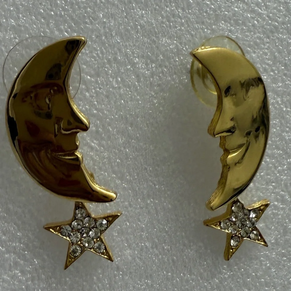 Pair of gold colored cresent earings with‎ star dangle